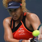 
              Naomi Osaka of Japan makes a return in her first round women's match against Astra Sharma of Australia, at the Miami Open tennis tournament, Wednesday, March 23, 2022, in Miami Gardens, Fla. (AP Photo/Rebecca Blackwell)
            