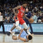 
              New Orleans Pelicans forward Naji Marshall (8) dribbles the ball as Memphis Grizzlies guard Tyus Jones (21) falls to the court during the first half of an NBA basketball game Tuesday, March 8, 2022, in Memphis, Tenn. (AP Photo/Brandon Dill)
            
