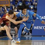 
              UCLA guard Tyger Campbell, right, and Southern California guard Drew Peterson go after a loose ball during the second half of an NCAA college basketball game Saturday, March 5, 2022, in Los Angeles. UCLA won 75-68. (AP Photo/Mark J. Terrill)
            