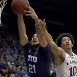 
              TCU forward JaKobe Coles (21) and Kansas forward Jalen Wilson (10) battle for a rebound during the first half of an NCAA college basketball game Thursday, March 3, 2022, in Lawrence, Kan. (AP Photo/Charlie Riedel)
            