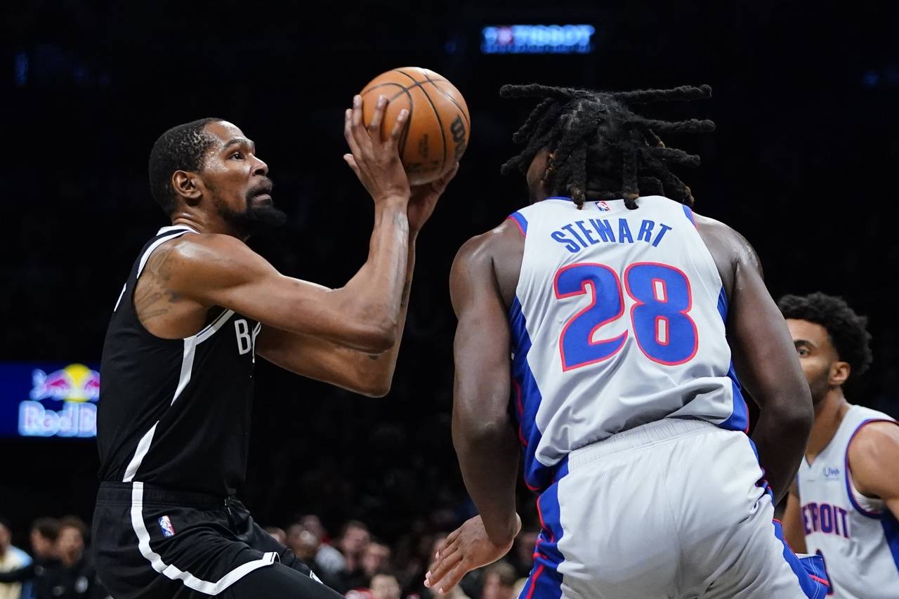 Brooklyn Nets' Kevin Durant, left, shoots over Detroit Pistons' Isaiah Stewart during the second ha...