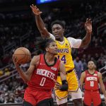 
              Houston Rockets' Jalen Green (0) goes up for a shot asw Los Angeles Lakers' Stanley Johnson (14) defends during the second half of an NBA basketball game Wednesday, March 9, 2022, in Houston. The Rockets won 139-130 in overtime. (AP Photo/David J. Phillip)
            
