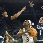
              Baylor guard Jordan Lewis (3) looks for an opening against Hawaii guards Kelsie Imai (1) and Daejah Phillips (15) during the first half of a college basketball game in the first round of the NCAA tournament in Waco, Texas, Friday, March 18, 2022. (AP Photo/LM Otero)
            