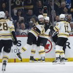 
              Boston Bruins' Craig Smith (12), Trent Frederic (11) and Charlie Coyle (13) celebrate Frederic's goal against the Winnipeg Jets during the second period of an NHL hockey game Friday, March 18, 2022 in Winnipeg, Manitoba.(John Woods/The Canadian Press via AP)
            
