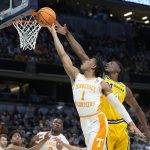 
              Tennessee's Kennedy Chandler (1) has his shot blocked by Michigan's Moussa Diabate (14) during the first half of a college basketball game in the second round of the NCAA tournament, Saturday, March 19, 2022, in Indianapolis. (AP Photo/Darron Cummings)
            