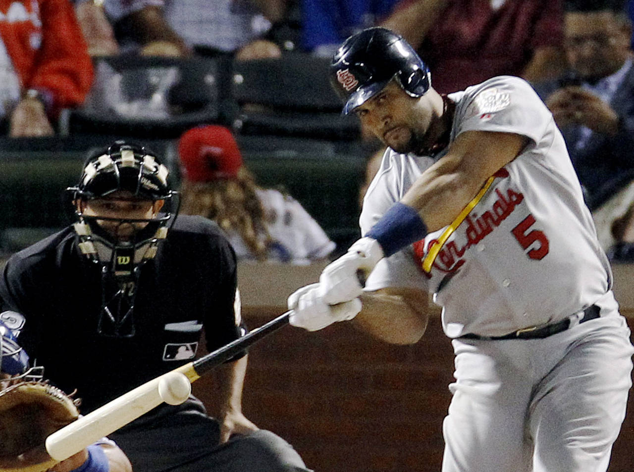 FILE - St. Louis Cardinals' Albert Pujols hits a solo home run during the ninth inning of Game 3 of...