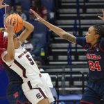 
              South Carolina's Victaria Saxton (5) pulls away from Mississippi's Madison Scott (24) in the first half of an NCAA college basketball semifinal round game at the women's Southeastern Conference tournament Saturday, March 5, 2022, in Nashville, Tenn. (AP Photo/Mark Humphrey)
            