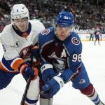 
              New York Islanders defenseman Noah Dobson, left, and Colorado Avalanche right wing Mikko Rantanen vie for the puck during the first period of an NHL hockey game Tuesday, March 1, 2022, in Denver. (AP Photo/David Zalubowski)
            