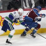 
              Vancouver Canucks defenseman Oliver Ekman-Larsson, left, knocks the puck away from Colorado Avalanche right wing Valeri Nichushkin during the first period of an NHL hockey game Wednesday, March 23, 2022, in Denver. (AP Photo/David Zalubowski)
            