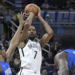 
              Brooklyn Nets forward Kevin Durant (7) shoots in front of Orlando Magic center Wendell Carter Jr., left, and center Mo Bamba (5) during the first half of an NBA basketball game Tuesday, March 15, 2022, in Orlando, Fla. (AP Photo/Phelan M. Ebenhack)
            