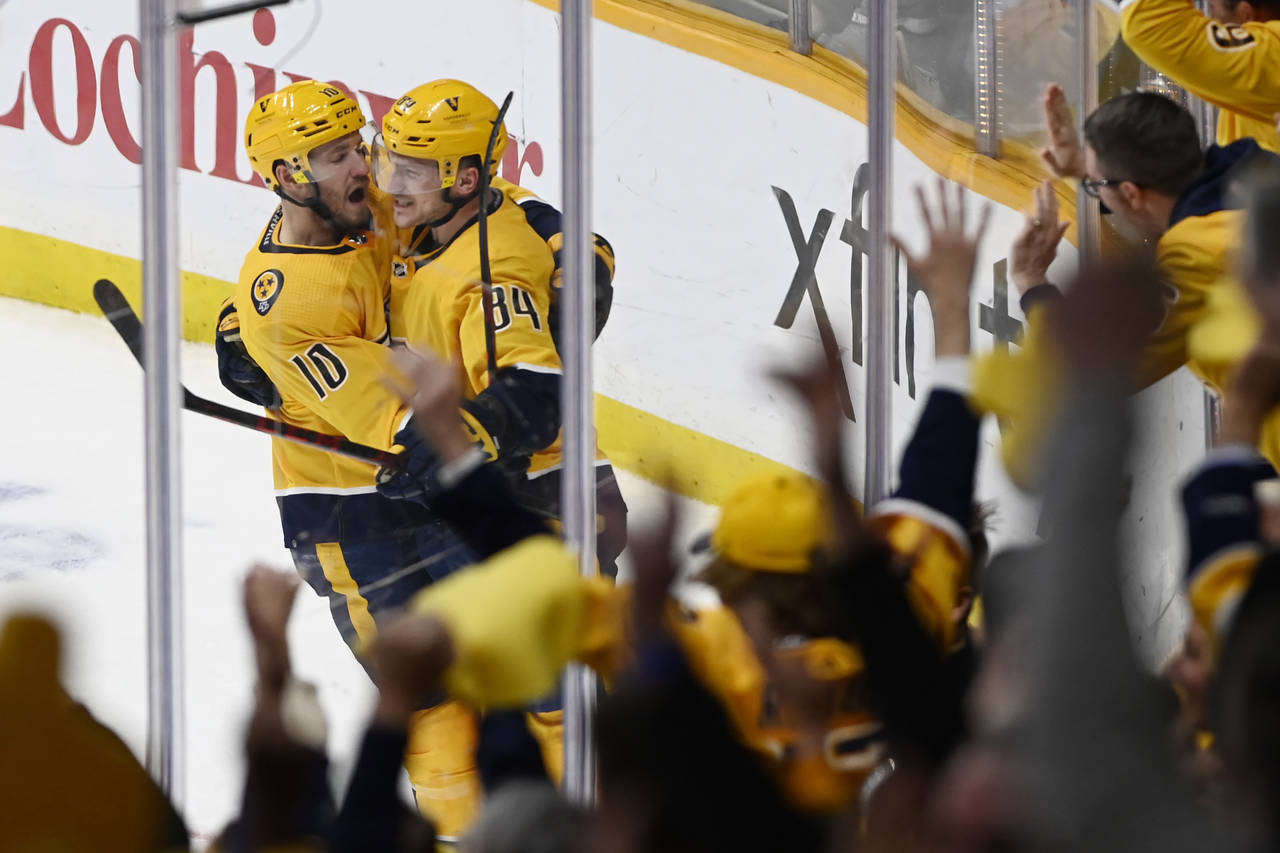 Nashville Predators' Tanner Jeannot (84) is congratulated by Colton Sissons (10) after Jeannot scor...