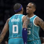 
              Charlotte Hornets forwards P.J. Washington (25) and Miles Bridges (0) bump chests during the first half of the  team's NBA basketball game against the Atlanta Hawks, Wednesday, March 16, 2022, in Charlotte, N.C. (AP Photo/Matt Kelley)
            