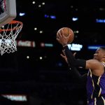 
              Los Angeles Lakers guard Russell Westbrook (0) shoots during the first half of an NBA basketball game against the Philadelphia 76ers in Los Angeles, Wednesday, March 23, 2022. (AP Photo/Ashley Landis)
            