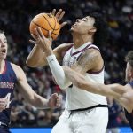 
              Saint Mary's Logan Johnson, right, fouls Gonzaga's Julian Strawther during the first half of an NCAA college basketball championship game at the West Coast Conference tournament Tuesday, March 8, 2022, in Las Vegas. (AP Photo/John Locher)
            