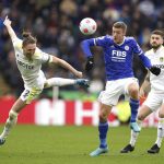 
              Leeds United's Luke Ayling, left, and Leicester City's Jamie Vardy battle for the ball during the English Premier League soccer match between Leicester City and Leeds United at the King Power Stadium, Leicester, England, Saturday, March 5, 2022. (Mike Egerton/PA via AP)
            