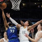 
              Minnesota Timberwolves center Karl-Anthony Towns (32) reaches for a rebound in front of Oklahoma City Thunder forward Isaiah Roby (22) in the first half of an NBA basketball game Friday, March 4, 2022, in Oklahoma City. (AP Photo/Sue Ogrocki)
            