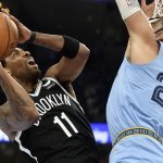 
              Brooklyn Nets guard Kyrie Irving (11) shoots against Memphis Grizzlies forward Dillon Brooks (24) during the first half of an NBA basketball game Wednesday, March 23, 2022, in Memphis, Tenn. (AP Photo/Brandon Dill)
            