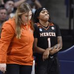 
              Mercer's Amoria Neal-Tysor (1) is helped off the court after she was injured during the first half of a first-round women's college basketball game against Connecticut in the NCAA tournament, Saturday, March 19, 2022, in Storrs, Conn. (AP Photo/Jessica Hill)
            