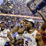 
              Auburn players celebrates winning the Southeastern Conference regular season championship after an NCAA college basketball game against South Carolina, Saturday, March 5, 2022, in Auburn, Ala. (AP Photo/Butch Dill)
            