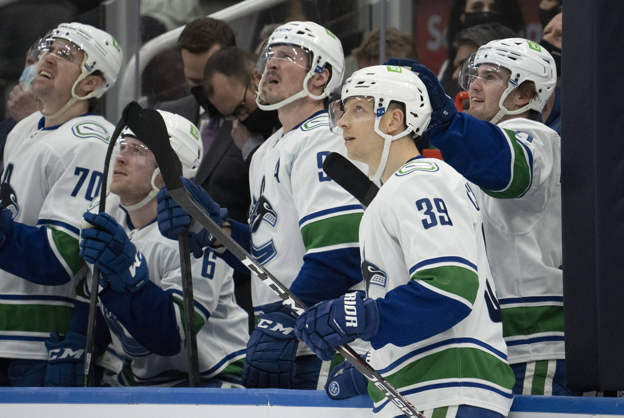 Vancouver Canucks right wing Alex Chiasson (39) is congratulated by Nils Hoglander, right, for his ...