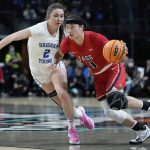 
              Gonzaga's Kayleigh Truong (11) drives around BYU's Shaylee Gonzales (2) during the first half of an NCAA women's championship college basketball game at the West Coast Conference tournament Tuesday, March 8, 2022, in Las Vegas. (AP Photo/John Locher)
            