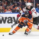 
              New Jersey Devils' Ryan Graves (33) and Edmonton Oilers' Zack Kassian (44) battle for the puck during the second period of an NHL hockey game in Edmonton, Alberta, Saturday, March 19, 2022. (Jason Franson/The Canadian Press via AP)
            
