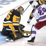 
              Pittsburgh Penguins goaltender Tristan Jarry (35) stops a shot attempt by New York Rangers' Dryden Hunt (29) during the first period of an NHL hockey game in Pittsburgh, Tuesday, March 29, 2022. (AP Photo/Gene J. Puskar)
            