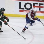 
              Colorado Avalanche left wing J.T. Compher (37) handles the puck against Minnesota Wild defenseman Jacob Middleton (5) during the first period of an NHL hockey game Sunday, March 27, 2022, in St. Paul, Minn. (AP Photo/Stacy Bengs)
            