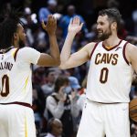 
              Cleveland Cavaliers' Darius Garland (10) and Kevin Love (0) celebrate a victory over the Toronto Raptors in an NBA basketball game, Sunday, March 6, 2022, in Cleveland. (AP Photo/Ron Schwane)
            
