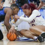 
              Kentucky's Dre'una Edwards, left, and LSU's Autumn Newby (0) fight for a loose ball in the first half of an NCAA college basketball game at the women's Southeastern Conference tournament Friday, March 4, 2022, in Nashville, Tenn. (AP Photo/Mark Humphrey)
            