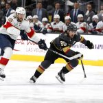 
              Florida Panthers left wing Jonathan Huberdeau (11) and Vegas Golden Knights center Chandler Stephenson (20) chase the puck during the first period of an NHL hockey game Thursday, March 17, 2022, in Las Vegas. (AP Photo/Steve Marcus)
            
