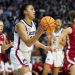 
              Connecticut guard Azzi Fudd (35) passes the ball against Indiana during the first quarter of a college basketball game in the Sweet Sixteen round of the NCAA women's tournament, Saturday, March 26, 2022, in Bridgeport, Conn. (AP Photo/Frank Franklin II)
            