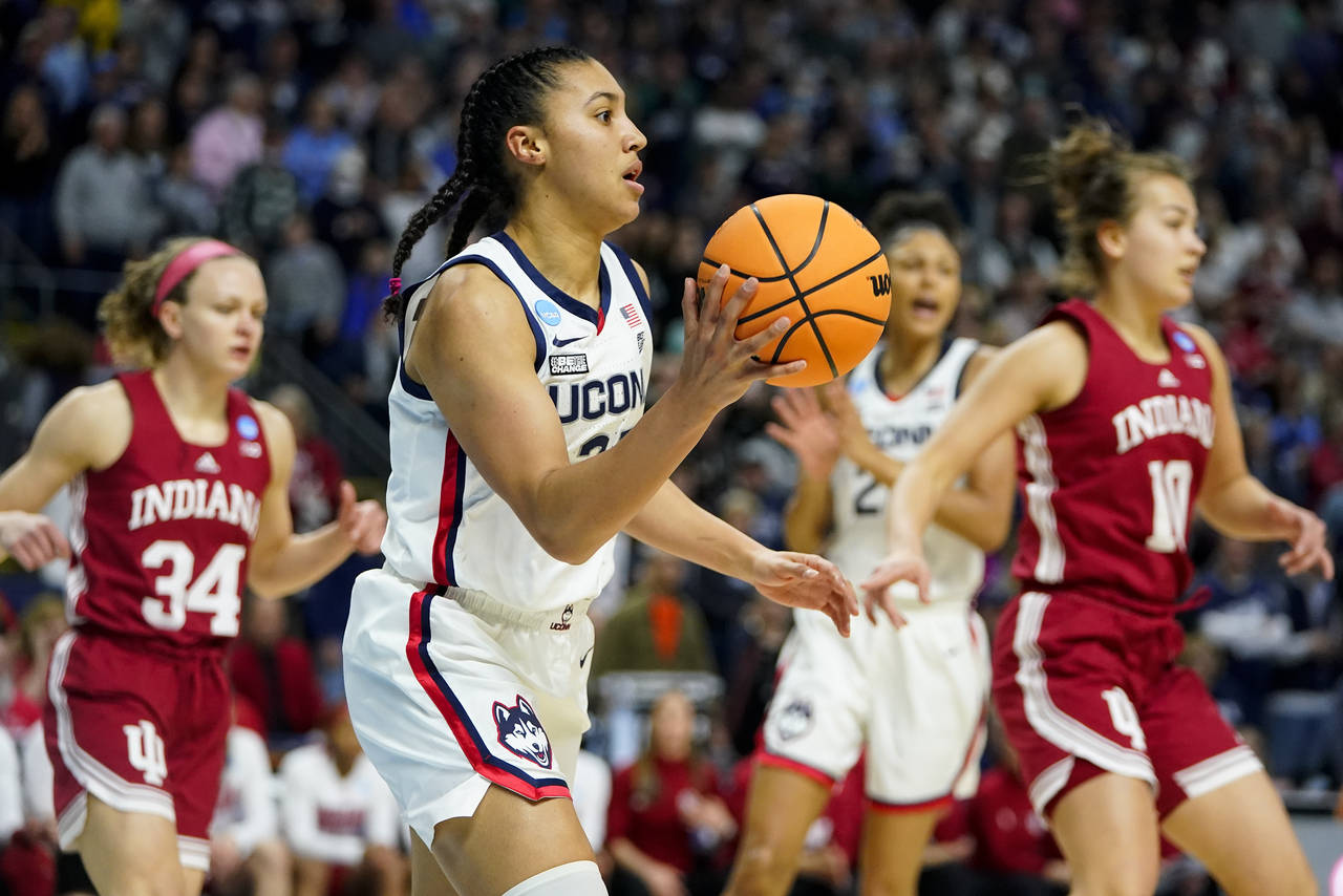 Connecticut guard Azzi Fudd (35) passes the ball against Indiana during the first quarter of a coll...