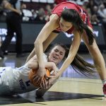 
              BYU's Shaylee Gonzales, left, and Gonzaga's Abby O'Connor (4) scramble for the ball during the first half of an NCAA women's championship college basketball game at the West Coast Conference tournament Tuesday, March 8, 2022, in Las Vegas. (AP Photo/John Locher)
            