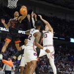 
              Miami guard Isaiah Wong (2) shoots against Auburn during the first half of a college basketball game in the second round of the NCAA tournament on Sunday, March 20, 2022, in Greenville, S.C. (AP Photo/Chris Carlson)
            