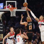 
              New York Knicks' Evan Fournier (13) shoots against Washington Wizards' Kyle Kuzma (33) during the first quarter of an NBA basketball game Friday, March 18, 2022, in New York. (AP Photo/Jason DeCrow)
            