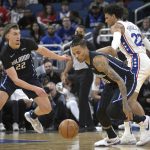 
              Orlando Magic guard Markelle Fultz, front, steals the ball from Philadelphia 76ers guard Matisse Thybulle (22) as Magic forward Franz Wagner (22), left, helps defend during the first half of an NBA basketball game, Sunday, March 13, 2022, in Orlando, Fla. (AP Photo/Phelan M. Ebenhack)
            