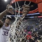
              Kansas forward David McCormack cuts the net after an NCAA college basketball championship game against Texas Tech in the Big 12 Conference tournament in Kansas City, Mo., Saturday, March 12, 2022. Kansas won 74-65. (AP Photo/Charlie Riedel)
            