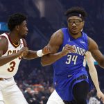 
              Orlando Magic's Wendell Carter Jr. (34) drives against Cleveland Cavaliers' Caris LeVert (3) during the first half of an NBA basketball game, Monday, March 28, 2022, in Cleveland. (AP Photo/Ron Schwane)
            