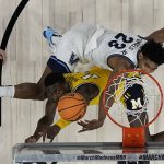 
              Villanova forward Jermaine Samuels fouls Michigan forward Moussa Diabate during the first half of a college basketball game in the Sweet 16 round of the NCAA tournament on Thursday, March 24, 2022, in San Antonio. (AP Photo/Eric Gay)
            