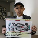 
              Ahmed, 12 years old, son of Mohammed Ramadhan, a former member of Bahrain's security forces who is facing the death penalty in Bahrain, holds a drawing he made of F1 driver Lewis Hamilton's Formula One car in Manama, Bahrain, Thursday, March 17, 2022. Ahead of Sunday's season-opening F1 race in Bahrain, Ahmed proudly held up the drawing of Hamilton's famed No. 44 Mercedes car along with his own words of hope: "Sir Lewis, another F1 where my innocent father is on death row. Please help free him." (AP Photo)
            