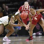 
              Baylor guard Jordan Lewis, left, and Oklahoma guard Kennady Tucker (4) reach for a loose ball during the second half of an NCAA college basketball game in the semifinal round of the Big 12 Conference tournament in Kansas City, Mo., Saturday, March 12, 2022. (AP Photo/Reed Hoffmann)
            