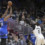 
              Orlando Magic center Wendell Carter Jr. (34) shoots in front of Brooklyn Nets center Andre Drummond (0) during the first half of an NBA basketball game Tuesday, March 15, 2022, in Orlando, Fla. (AP Photo/Phelan M. Ebenhack)
            