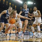 
              Michigan guard Danielle Rauch (23) control the ball on the baseline during the first half of a college basketball game in the second round of the NCAA tournament against Villanova, Monday, March 21, 2022, in Ann Arbor, Mich. (AP Photo/Carlos Osorio)
            
