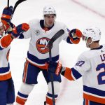 
              New York Islanders' Anders Lee (27) celebrates his goal with Mathew Barzal (13) and Jean-Gabriel Pageau (44) during the second period of an NHL hockey game against the Boston Bruins, Saturday, March 26, 2022, in Boston. (AP Photo/Michael Dwyer)
            