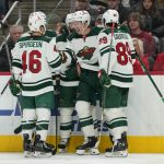 
              Minnesota Wild left wing Matt Boldy, center, celebrates his goal against the Detroit Red Wings in the third period of an NHL hockey game Thursday, March 10, 2022, in Detroit. (AP Photo/Paul Sancya)
            