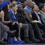 
              Golden State Warriors owner Joe Lacob, middle left, talks with Kanye West during the first half of an NBA basketball game between the Warriors and the Boston Celtics in San Francisco, Wednesday, March 16, 2022. (AP Photo/Jeff Chiu)
            
