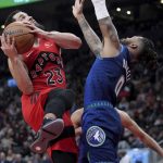 
              Toronto Raptors guard Fred VanVleet (23) is fouled by Minnesota Timberwolves guard D'Angelo Russell (0) during the first half of an NBA basketball game Wednesday, March 30, 2022, in Toronto. (Nathan Denette/The Canadian Press via AP)
            