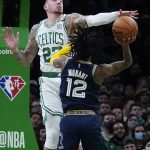 
              Boston Celtics center Daniel Theis (27) blocks a shot by Memphis Grizzlies guard Ja Morant (12) during the second half of an NBA basketball game, Thursday, March 3, 2022 in Boston. The Celtics defeated the Grizzlies 120-107. (AP Photo/Charles Krupa)
            