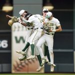 
              Baylor's Kyle Nevin (23), Tre Richardson (0), Jack Pineda, left, and Jared McKenzie celebrate after an NCAA college baseball game against UCLA at Minute Maid Park, home of the Houston Astros, during the Shriners Children's College Classic, Friday, March 4, 2022, in Houston. College baseball might turn out to be an attractive alternative for baseball fans if the Major League Baseball lockout extends deep into the spring. (AP Photo/David J. Phillip)
            